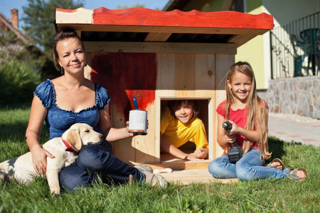 family with dog and diy dog house