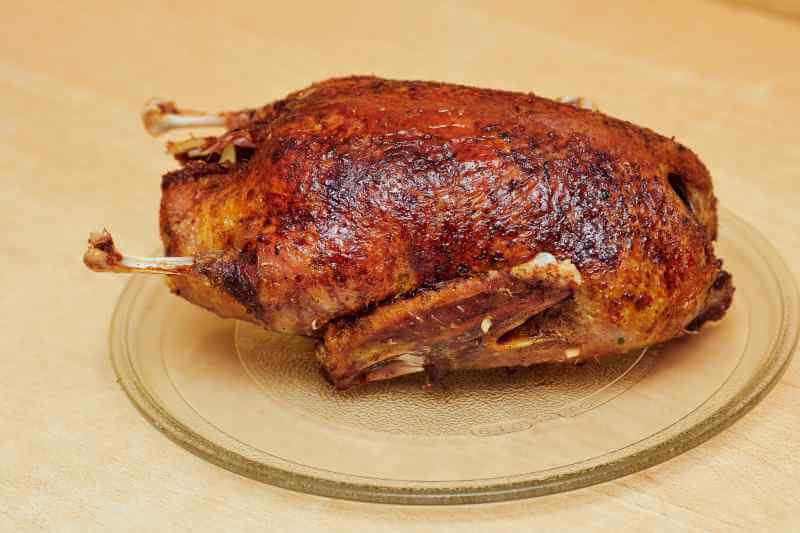 cooked duck on a glass plate